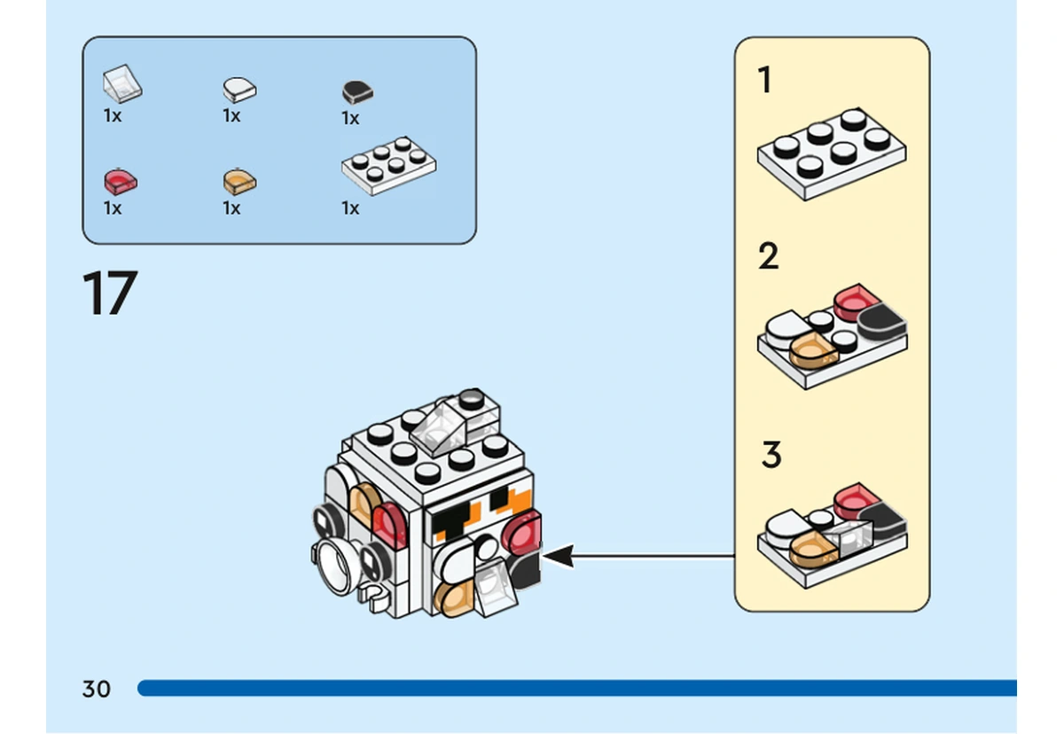 Notice officielle LEGO 40545, livret 6428250, page 30, étape 17 : Un sous-ensemble de plaques blanches, de tuiles noires et d’éléments transparents rouges et orange recouvre un côté du petit poisson.