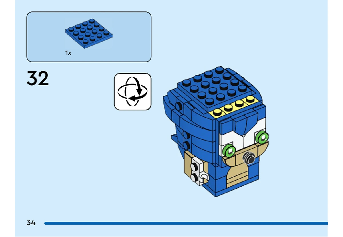 Notice officielle LEGO 40627, livret 6505943, page 34, étape 32 : Après la vue retournée, une plaque bleue 4 × 4 recouvre le sommet de la tête. Les yeux verts et le museau sont déjà installés.