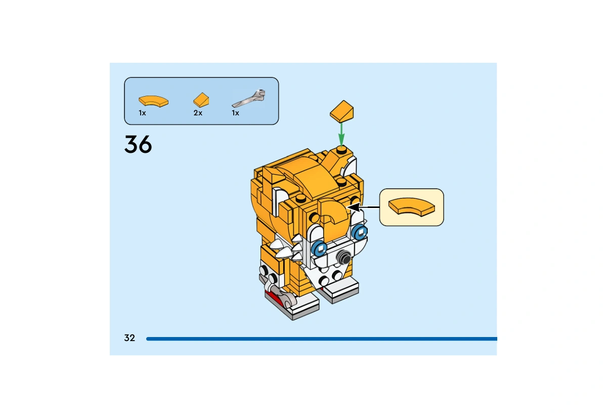 Notice officielle LEGO 40628, livret 6505944, page 32, étape 36 : Une tuile courbe orange clair est fixée sur le front et deux petites pentes complètent les oreilles. La clé argentée figure dans l’encadré de pièces ; cette vue ne montre pas son installation.