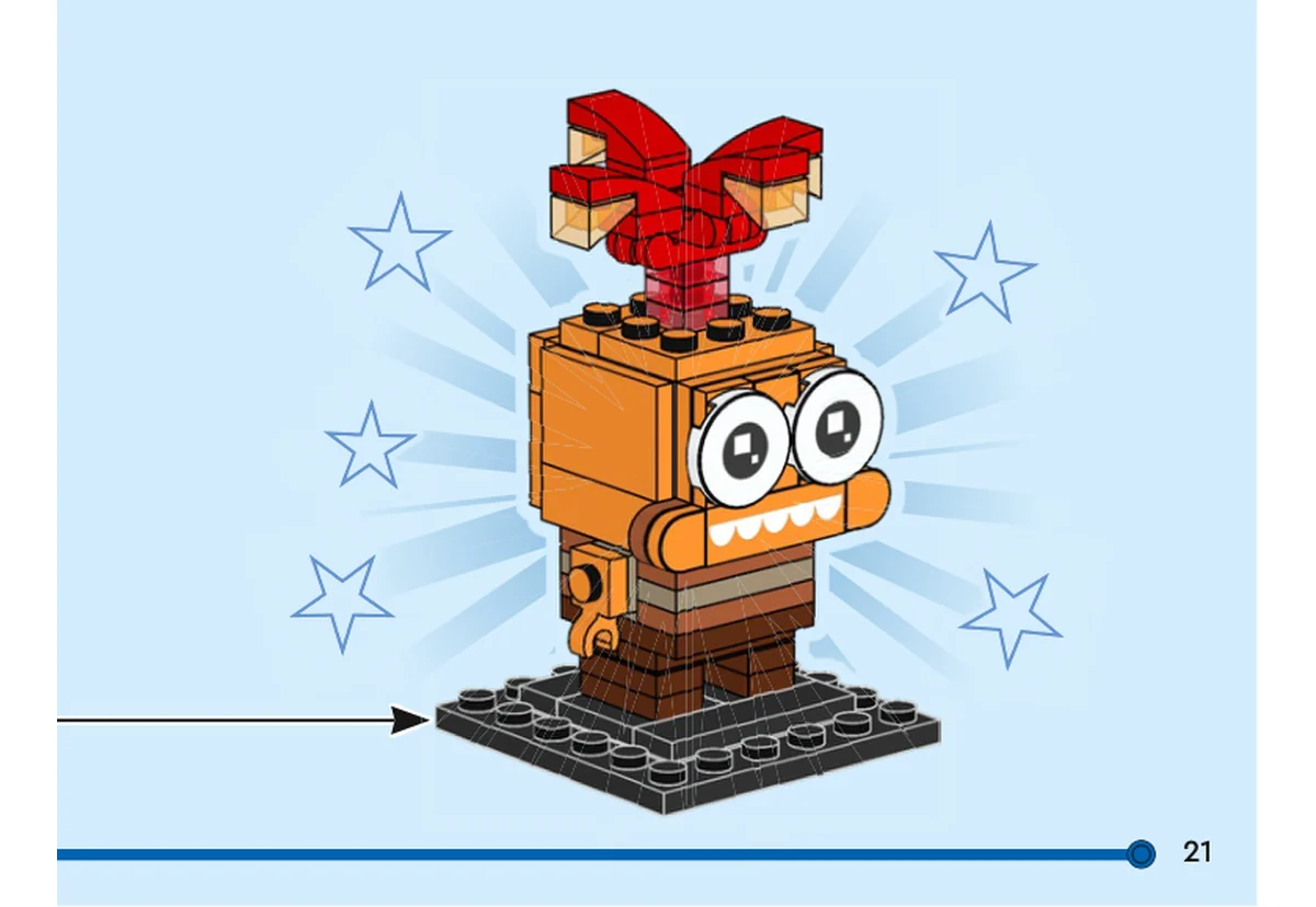 Notice officielle LEGO 40749, livret 6521403, page 21, étape vue finale : La vue finale montre Anxiété sur son socle noir : deux grands yeux blancs, une bouche orange imprimée de cinq demi-cercles blancs et deux branches de cheveux rouges et orange translucide relevées au-dessus de la tête.