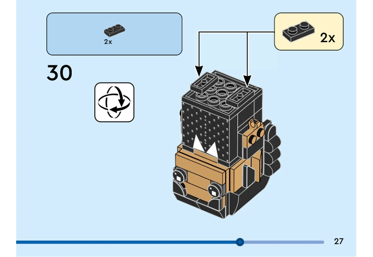 Notice officielle LEGO 40750, livret 6536733, page 27, étape 30 : Le pictogramme demande de retourner le modèle. Deux plaques noires 1 × 2 se fixent sous le corps, au-dessus du visage dans cette orientation inversée. Les tresses et le col imprimé permettent de reconnaître le sens du personnage.
