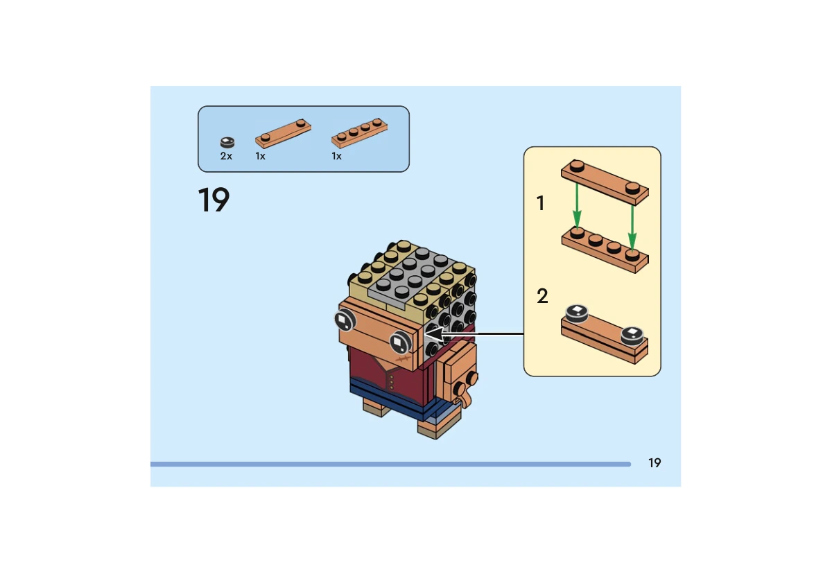 Notice officielle LEGO 40799, livret 6592656, page 19, étape 19 : Une plaque nougat 1  ×  4 à deux tenons rejoint une plaque nougat 1  ×  4 ordinaire. Deux yeux ronds noirs y sont posés ; ce panneau se fixe au-dessus de la partie du visage portant la cicatrice.