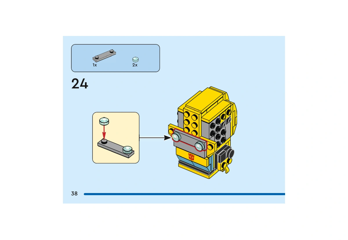 Notice officielle LEGO 40804, livret 6566709, page 38, étape 24 : Une pièce grise 1×4 reçoit deux tuiles rondes d’œil bleu clair transparent. Ce sous-ensemble est ensuite fixé sur l’avant de la tête.