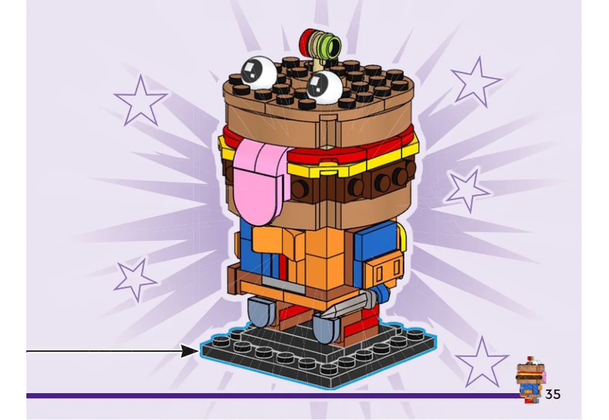 Notice officielle LEGO 40910, livret 6633498, page 35, étape vue finale : Le modèle achevé est présenté sur son socle noir, avec son pain arrondi, ses deux yeux blancs, ses couches colorées et sa grande langue rose descendant devant le corps.